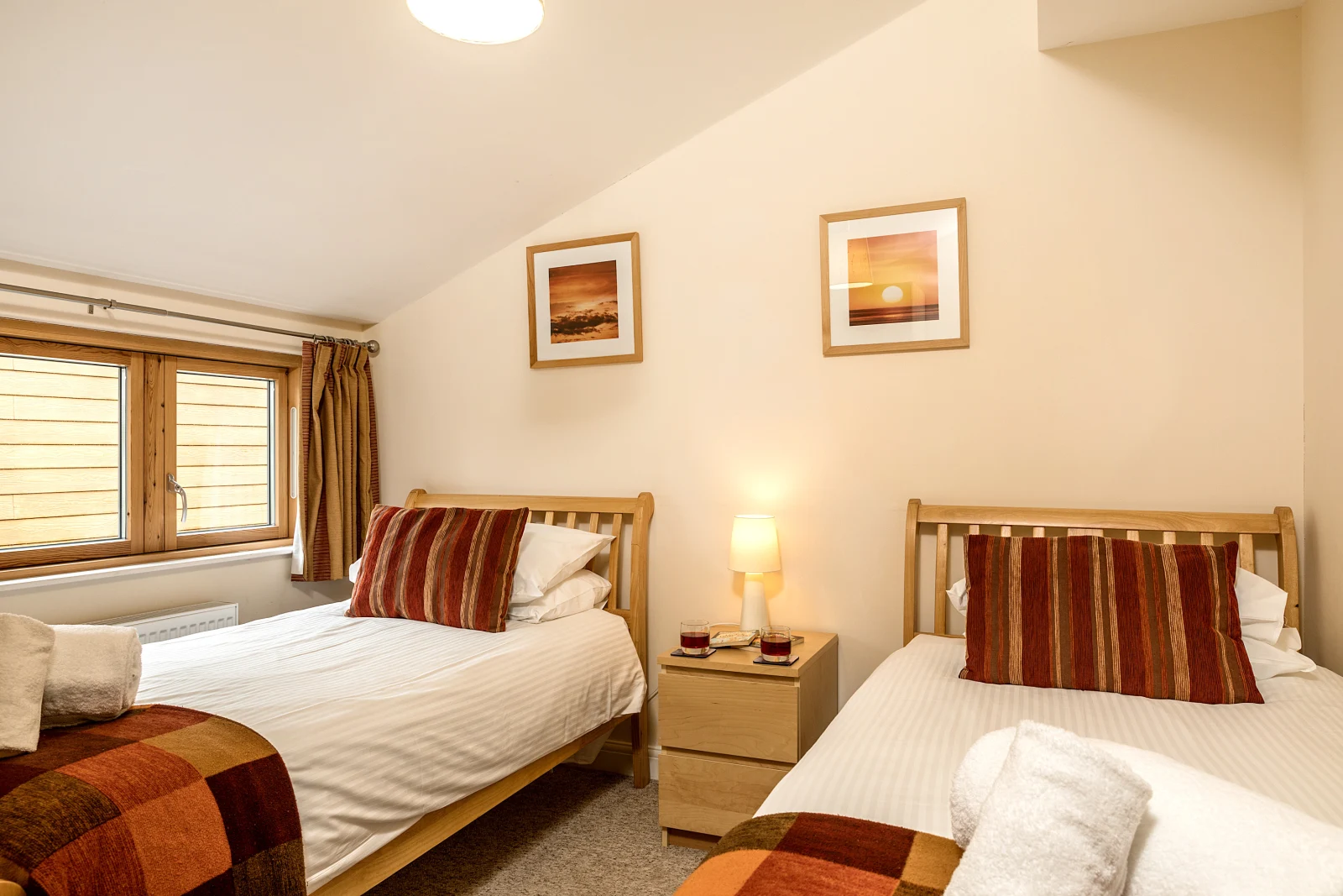 The third bedroom has a set of twins, wardrobe and chest of drawers.