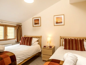 The third bedroom has a set of twins, wardrobe and chest of drawers.