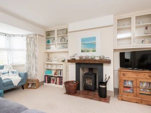 The living room is cosy and tasteful with a log burner for cooler evenings