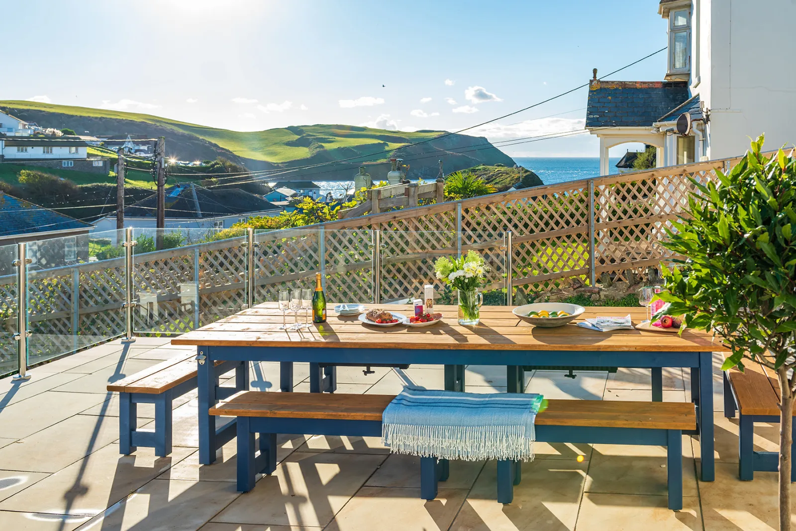 The large outside dining table, with built in bottle holders, and glorious sea views! 