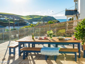 The large outside dining table, with built in bottle holders, and glorious sea views! 