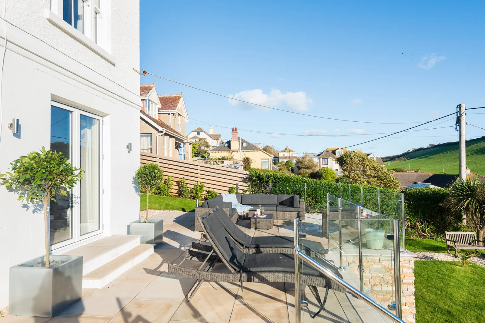 The sun terrace with sun loungers, and a comfortable outdoor sofa. 