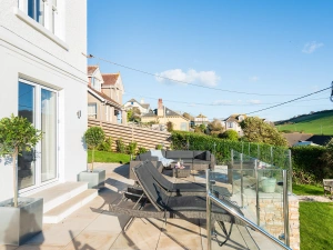 The sun terrace with sun loungers, and a comfortable outdoor sofa. 