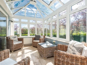The sun room offers additional living space and views over the tranquil garden
