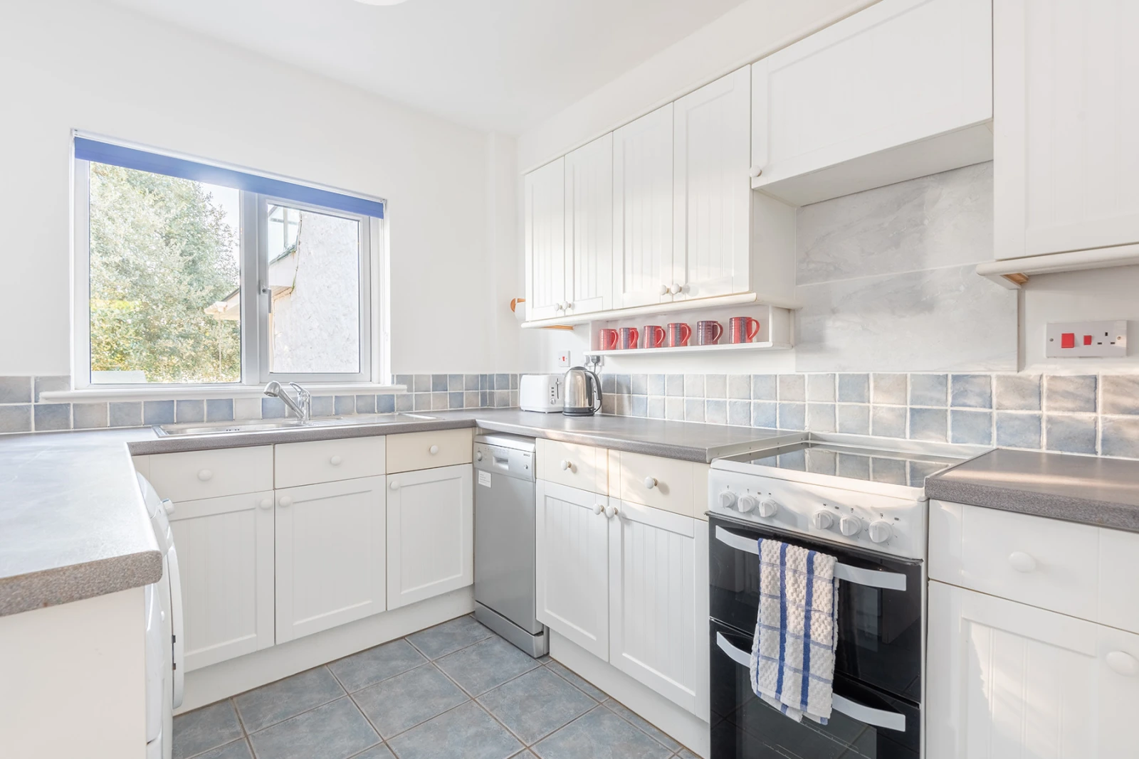 The kitchen is fully equipped with full size appliances