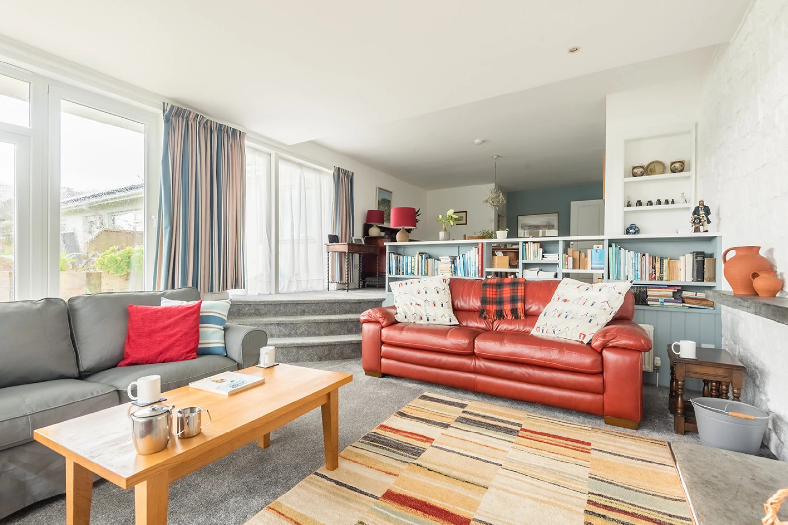 The layout of the living room with three steps up to the dining area.
