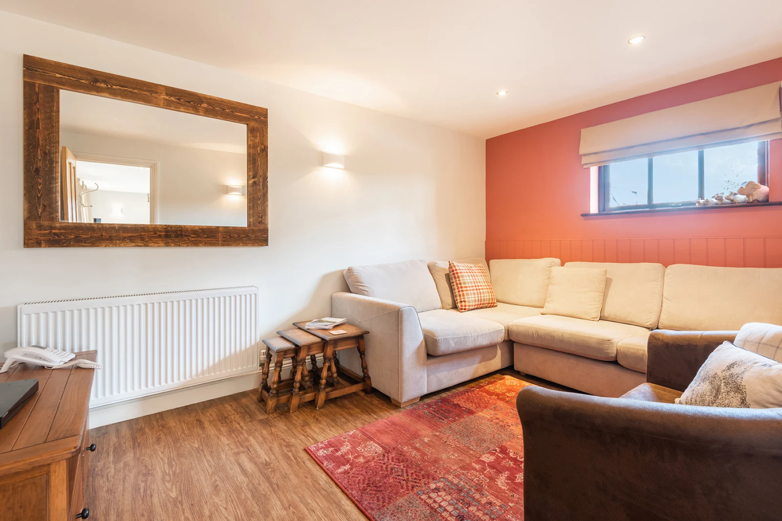 Another view of the lounge which is furnished with a sofabed.