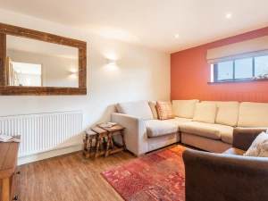 Another view of the lounge which is furnished with a sofabed.