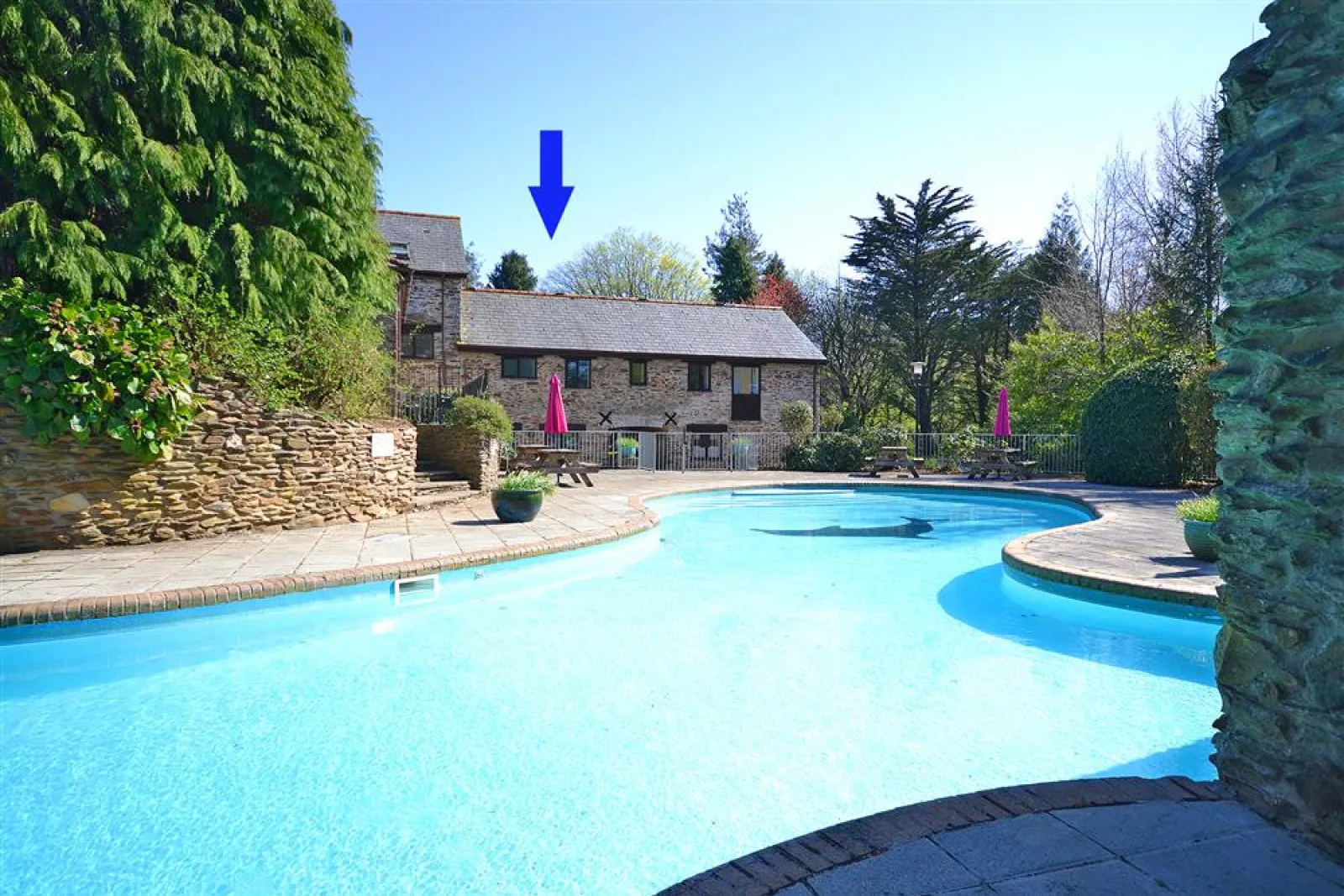 Colmer outdoor swimming pool with Gatehouse East arrowed