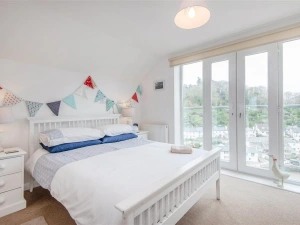Beautiful master bedroom with waterside view
