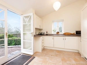 Patio doors lead to outside. 