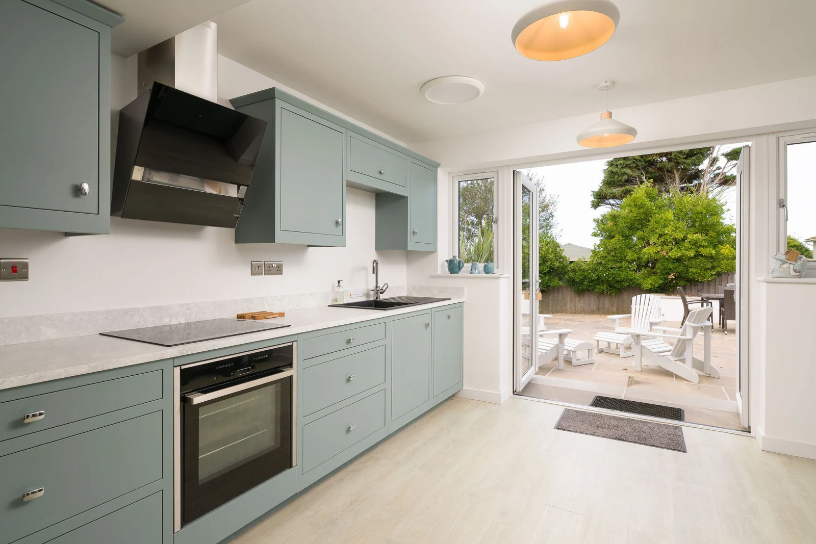 Modern kitchen with doors to outside 