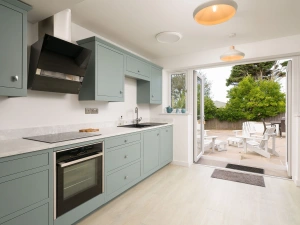 Modern kitchen with doors to outside 