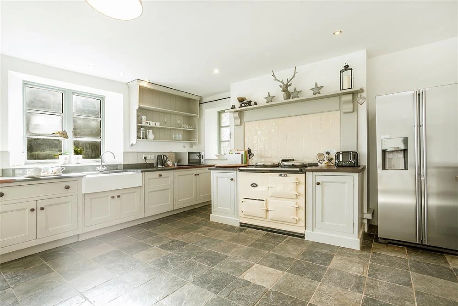 The huge farmhouse kitchen with AGA.