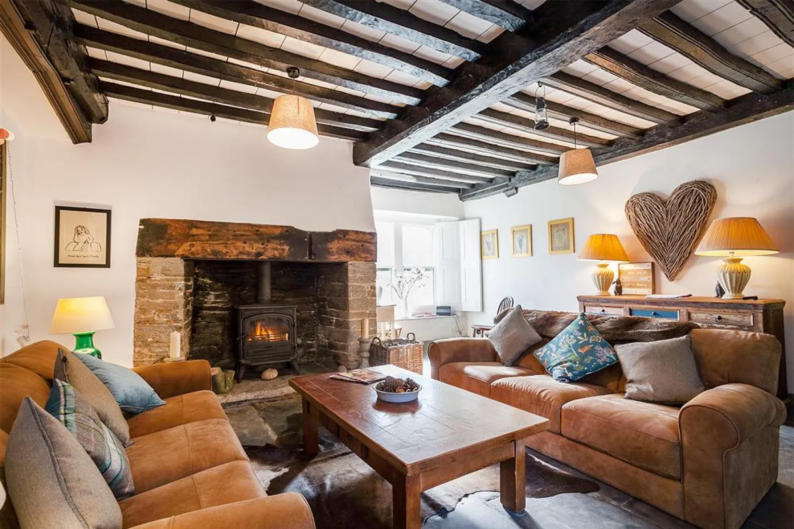 The gorgeous snug with beamed ceiling, slate floors, comfy sofas and log burner. 