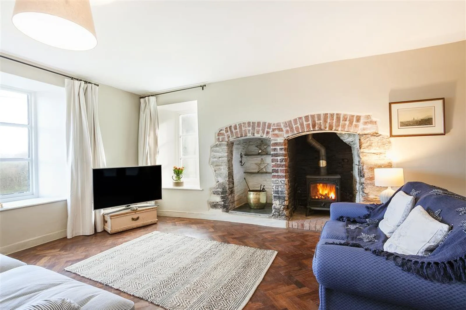The more formal lounge, light and airy again with lovely character features and log burner.
