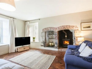 The more formal lounge, light and airy again with lovely character features and log burner.