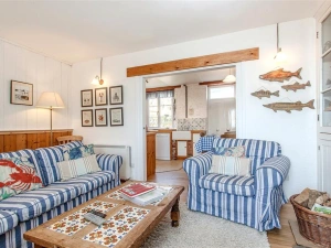 Another view of the sitting room with wood burner stove.
