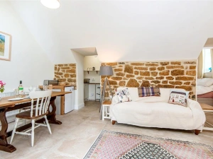 Open plan living area with sofa and dining table