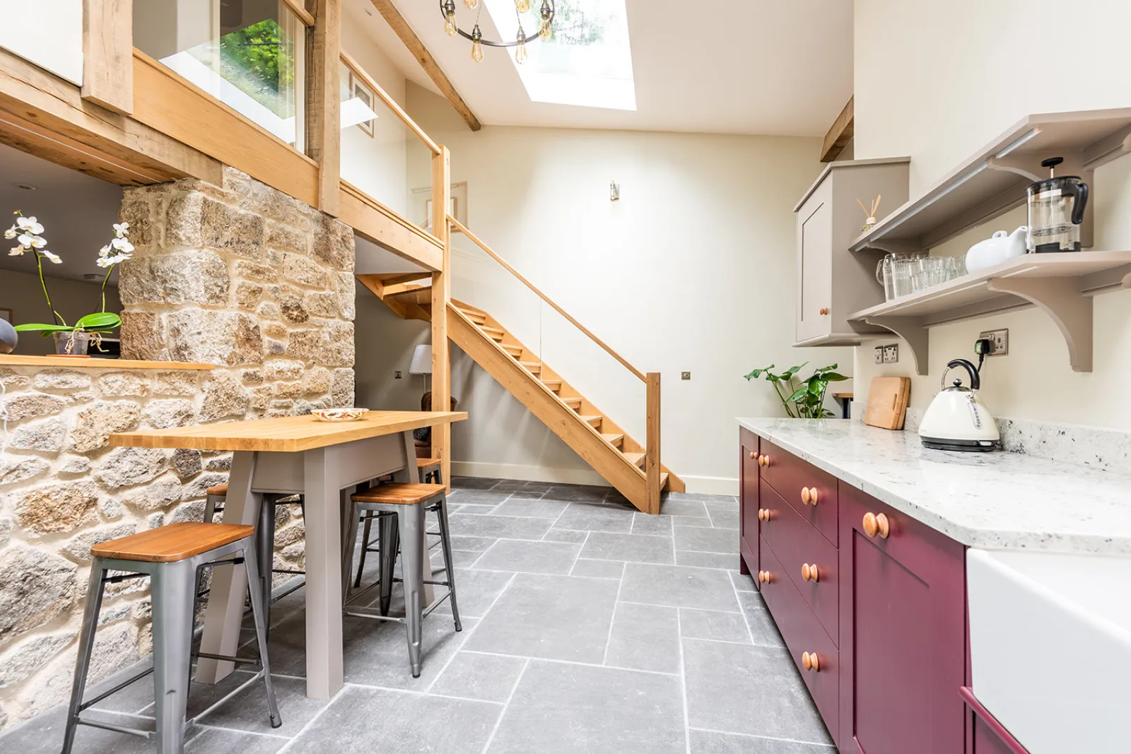 Kitchen with high ceilings and raised table with stool seating