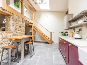 Kitchen with high ceilings and raised table with stool seating