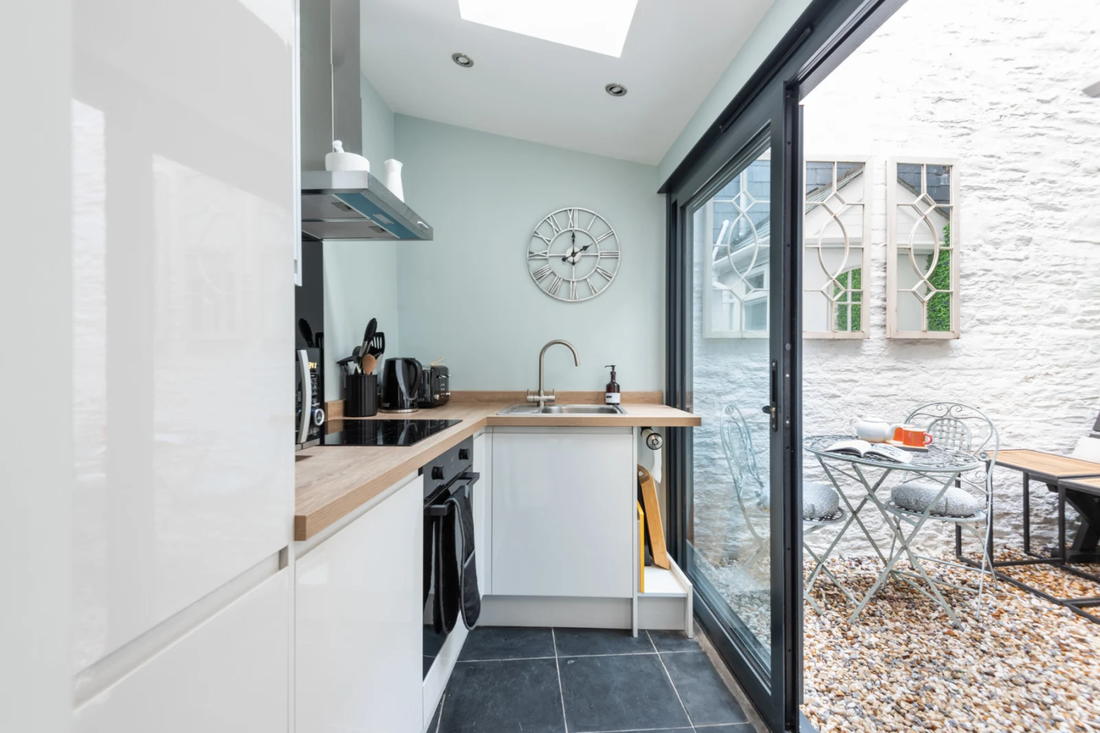 The modern fitted kitchen opens out on to the little courtyard space.