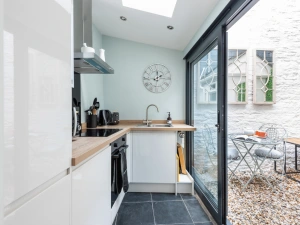 The modern fitted kitchen opens out on to the little courtyard space.