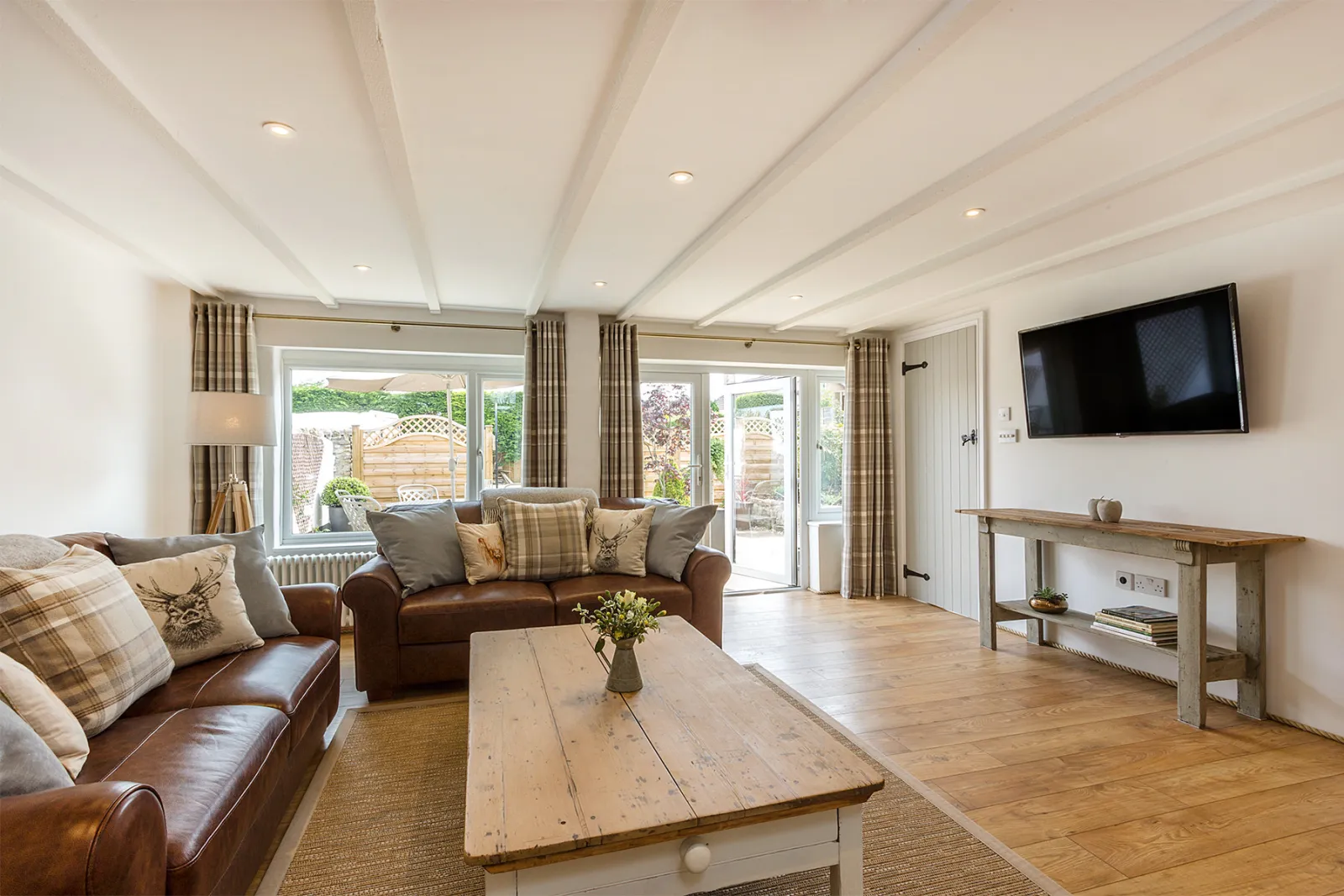 The Living room with sofas and large flatscreen tv