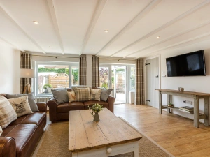 The Living room with sofas and large flatscreen tv