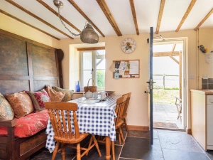 Dining table within kitchen/dining room with access to the rear garden 