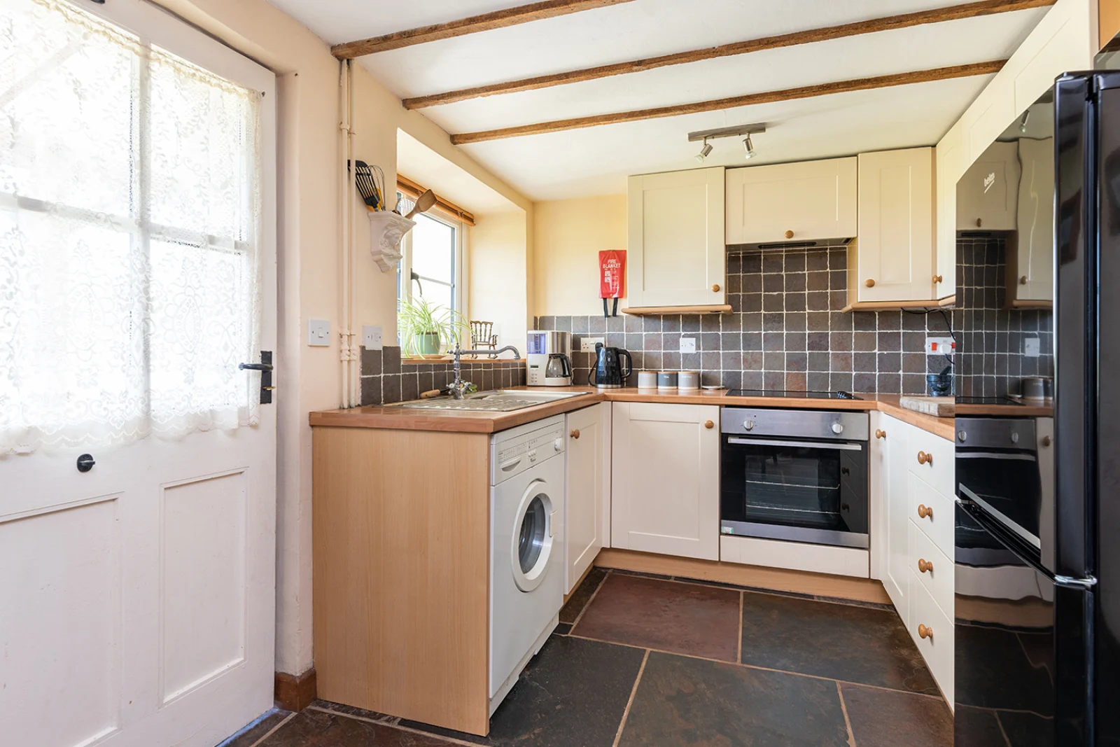 Kitchen area within kitchen/dining room with access to the rear garden
