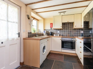 Kitchen area within kitchen/dining room with access to the rear garden
