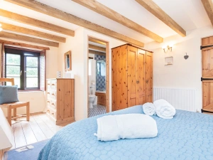 The second huge bedroom with en-suite and French windows to the decked terrace