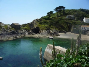 The little tidal beach and caves in the mouth of Polperro