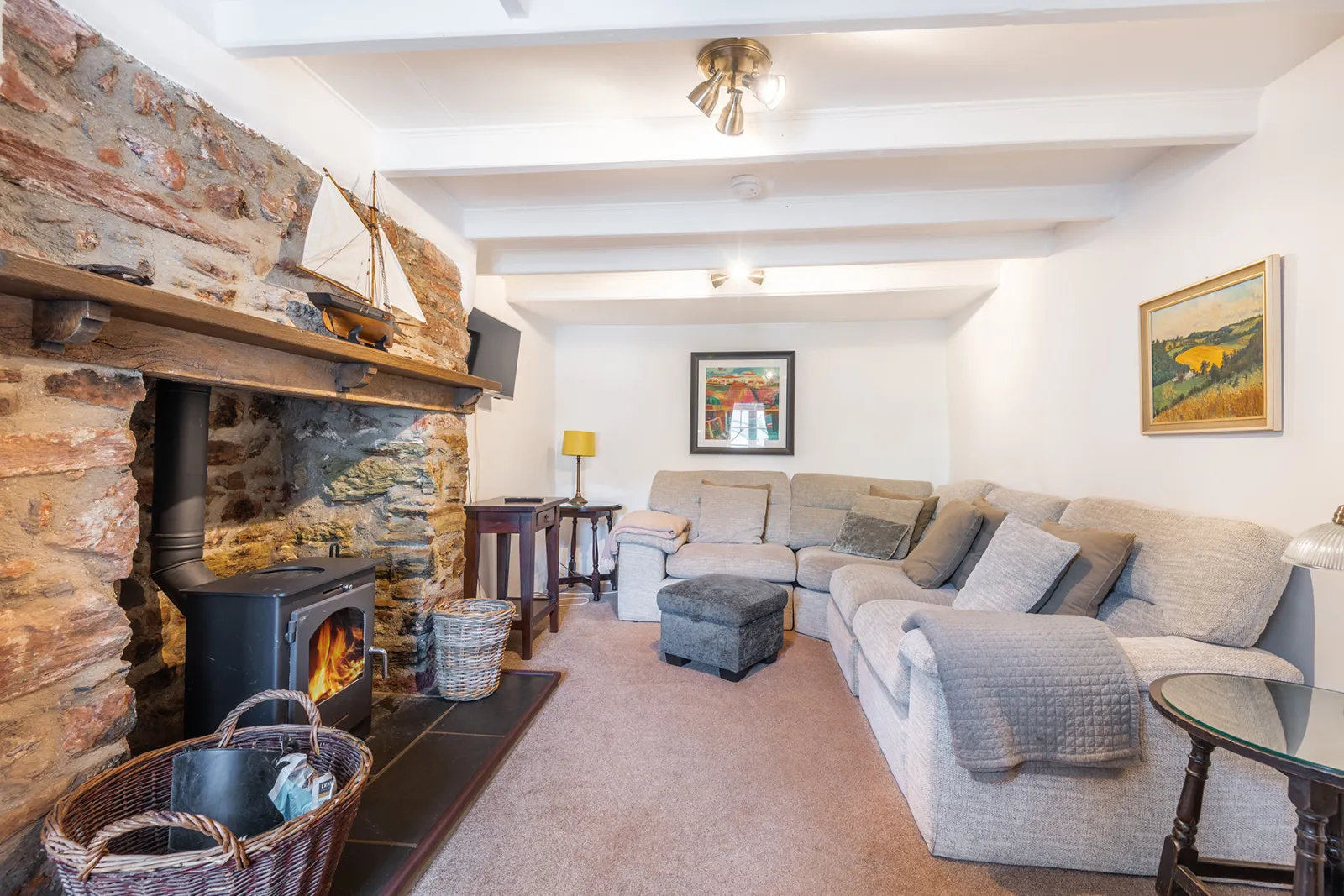 The comfortable lounge with feature fireplace with inset wood-burner. 