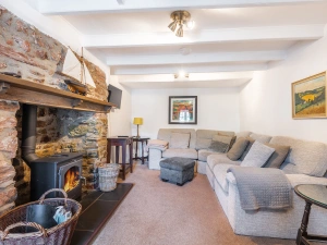 The comfortable lounge with feature fireplace with inset wood-burner. 
