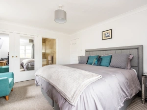 Spacious master bedroom with smart TV and super king size bed.