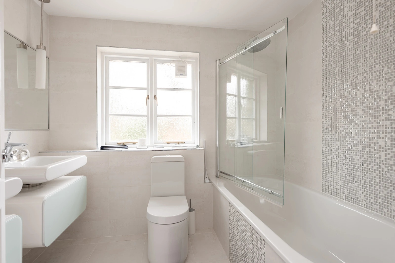 Family bathroom with shower over bath.