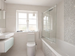 Family bathroom with shower over bath.