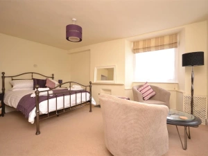 The spacious master bedroom with a seating area.