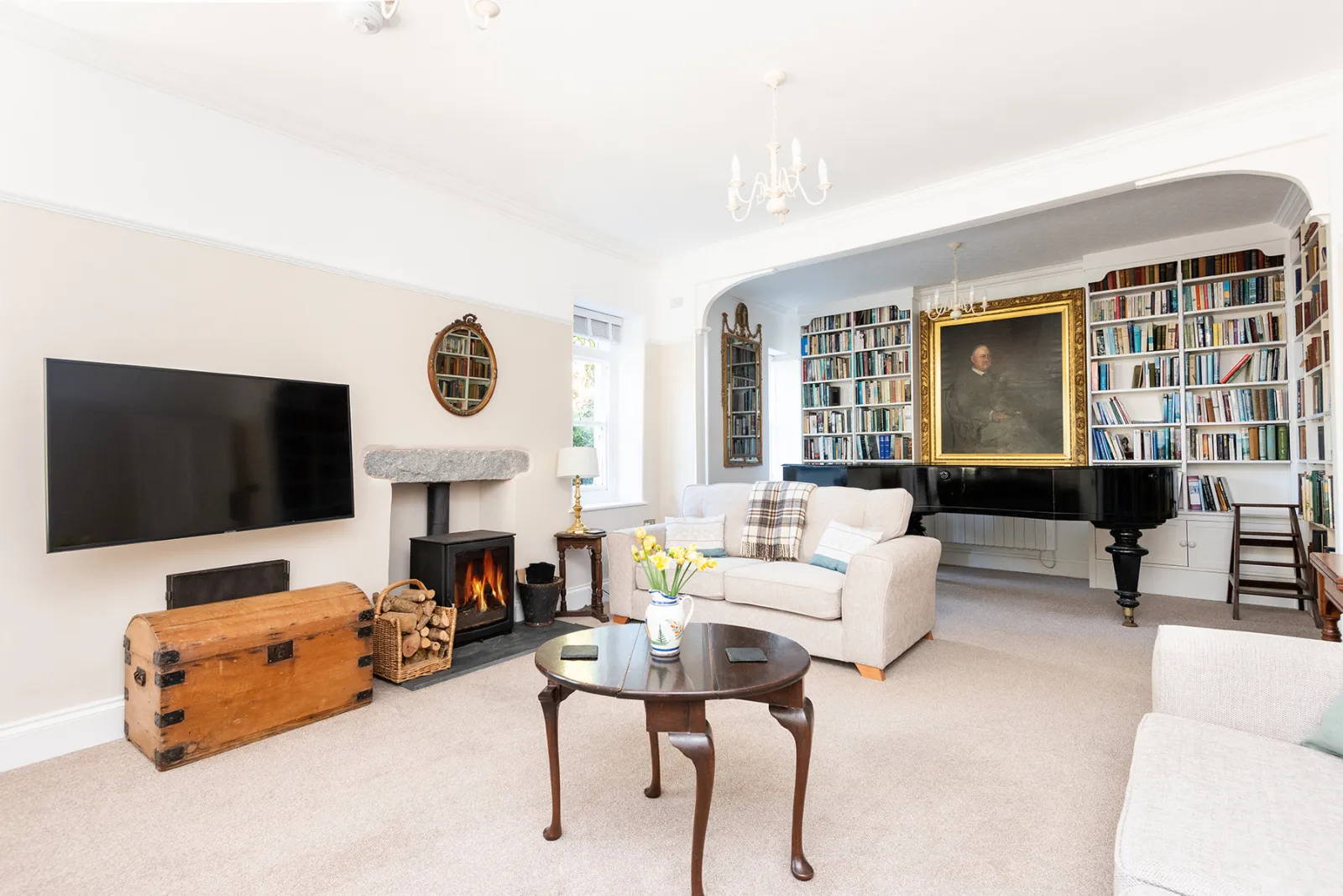 Lounge with seating for 8 with wood burning stove and piano for guests use.