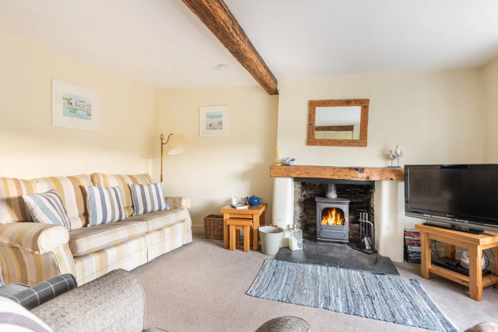 Another view of the cosy lounge with log burner.