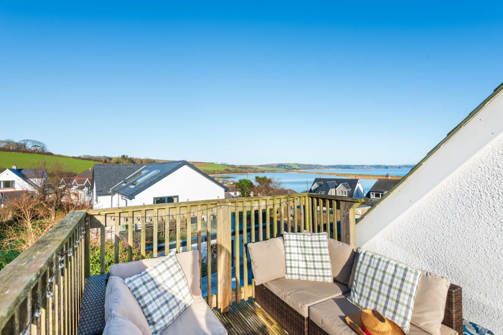 The rear deck with direct view to the field beyond and around the house to the water.