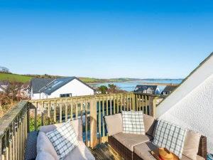 The rear deck with direct view to the field beyond and around the house to the water.