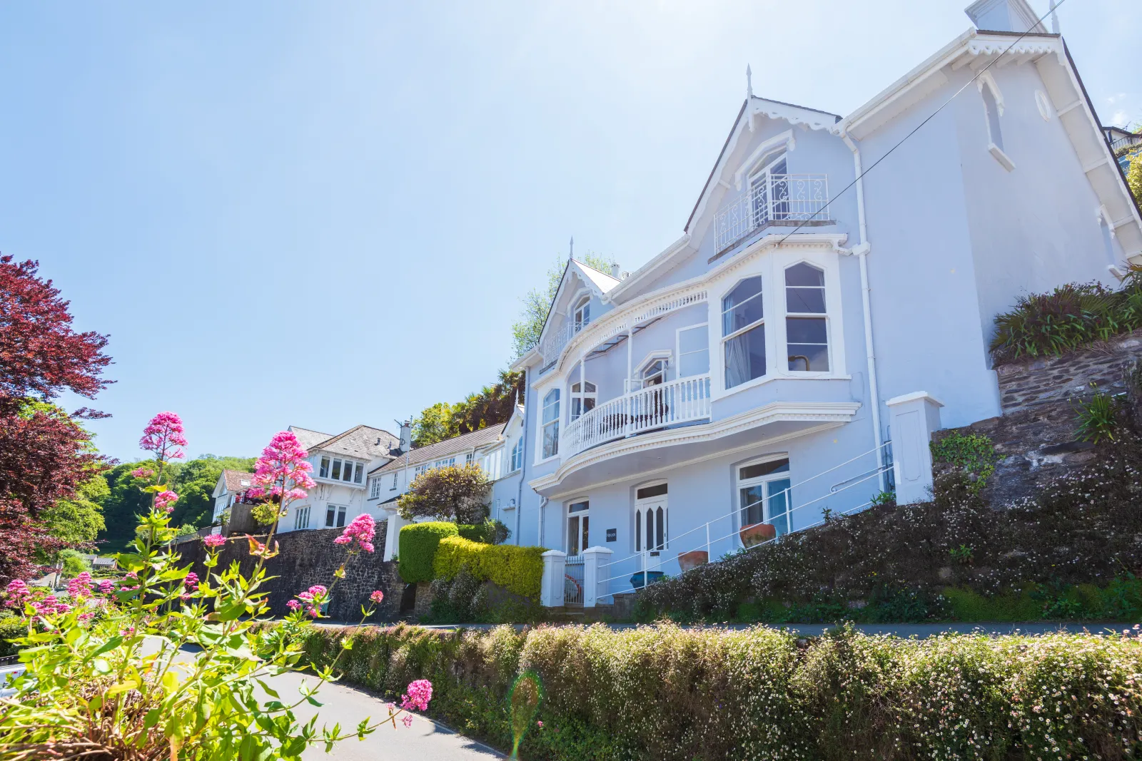 Grand period property with iconic bay windows and front balcony.