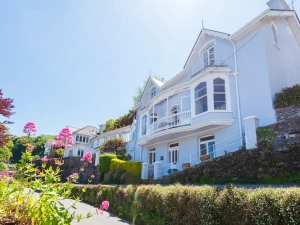 Grand period property with iconic bay windows and front balcony.