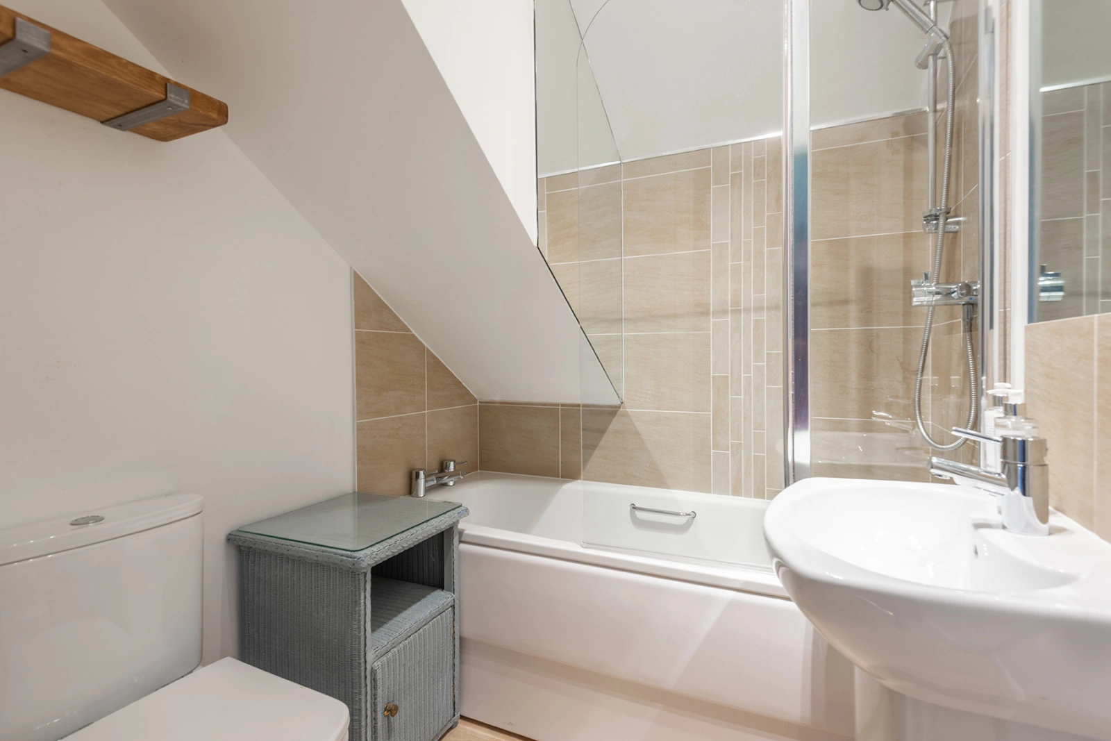 The bathroom with bath and over head shower