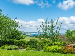 A beautiful garden looking down over the fields to Start Bay from this pretty holiday home in Devon