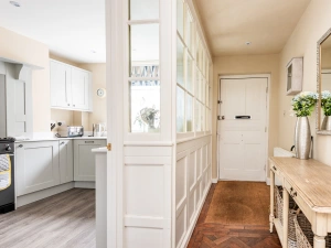 Entrance hallway with feature window wall through to the kitchen.