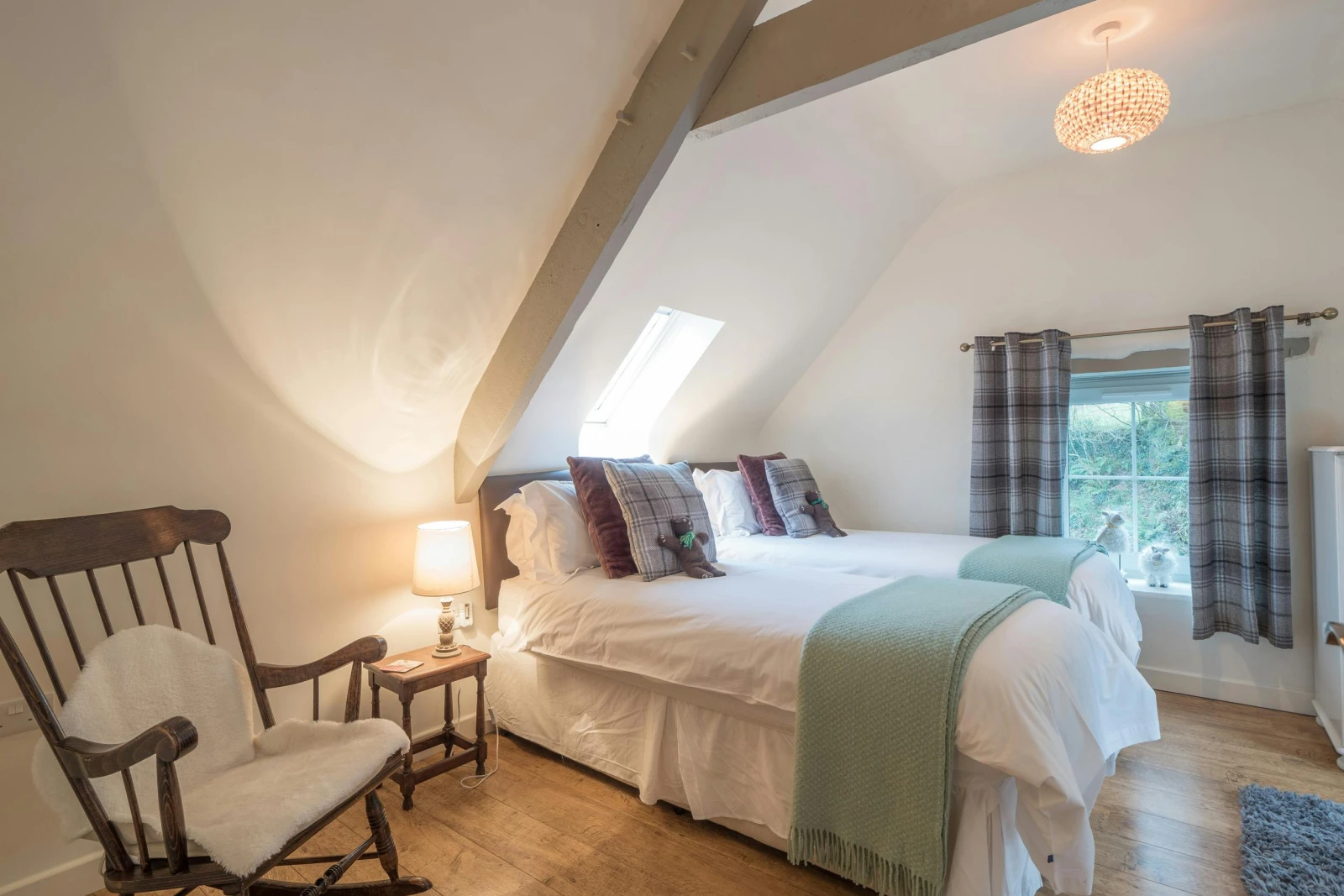 Twin  single beds, bedside table with lamp and rocking chair